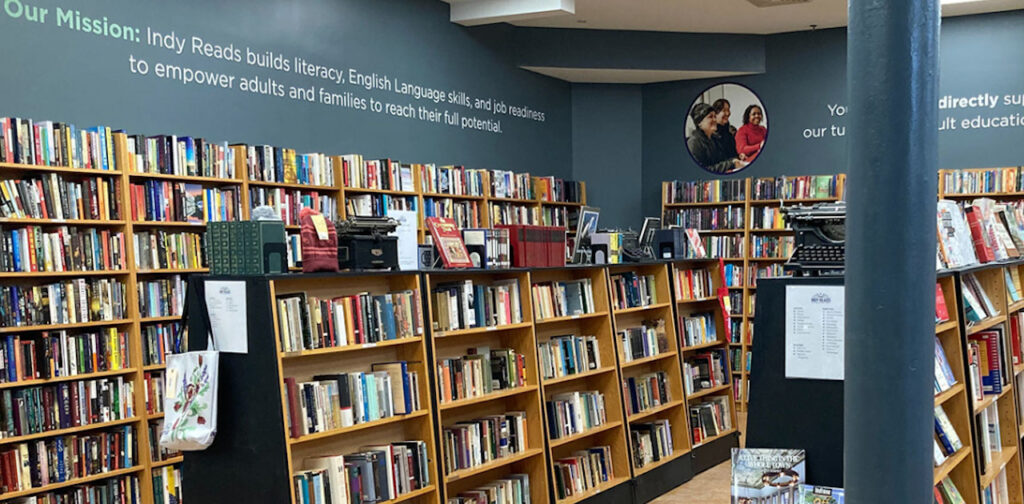 Inside Indy Reads' bookstore with several shelves of new and used books.