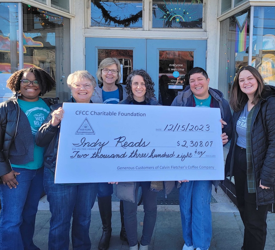 A large check is presented to the team at Indy Reads from the CFCC Charitable Foundation