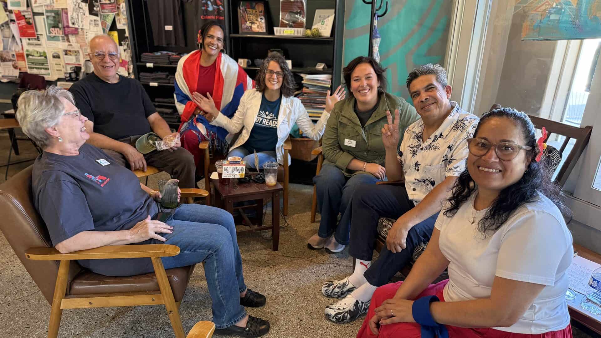 Indy Reads staff and supporters smile together in armchairs at Calvin Fletcher’s Coffee Company during BLEND 2026