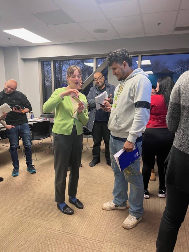 A volunteer talks with adult learners in an Indy Reads classroom
