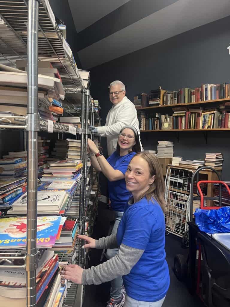 Volunteers sort and shelve books in the bookstore during a Day of Service