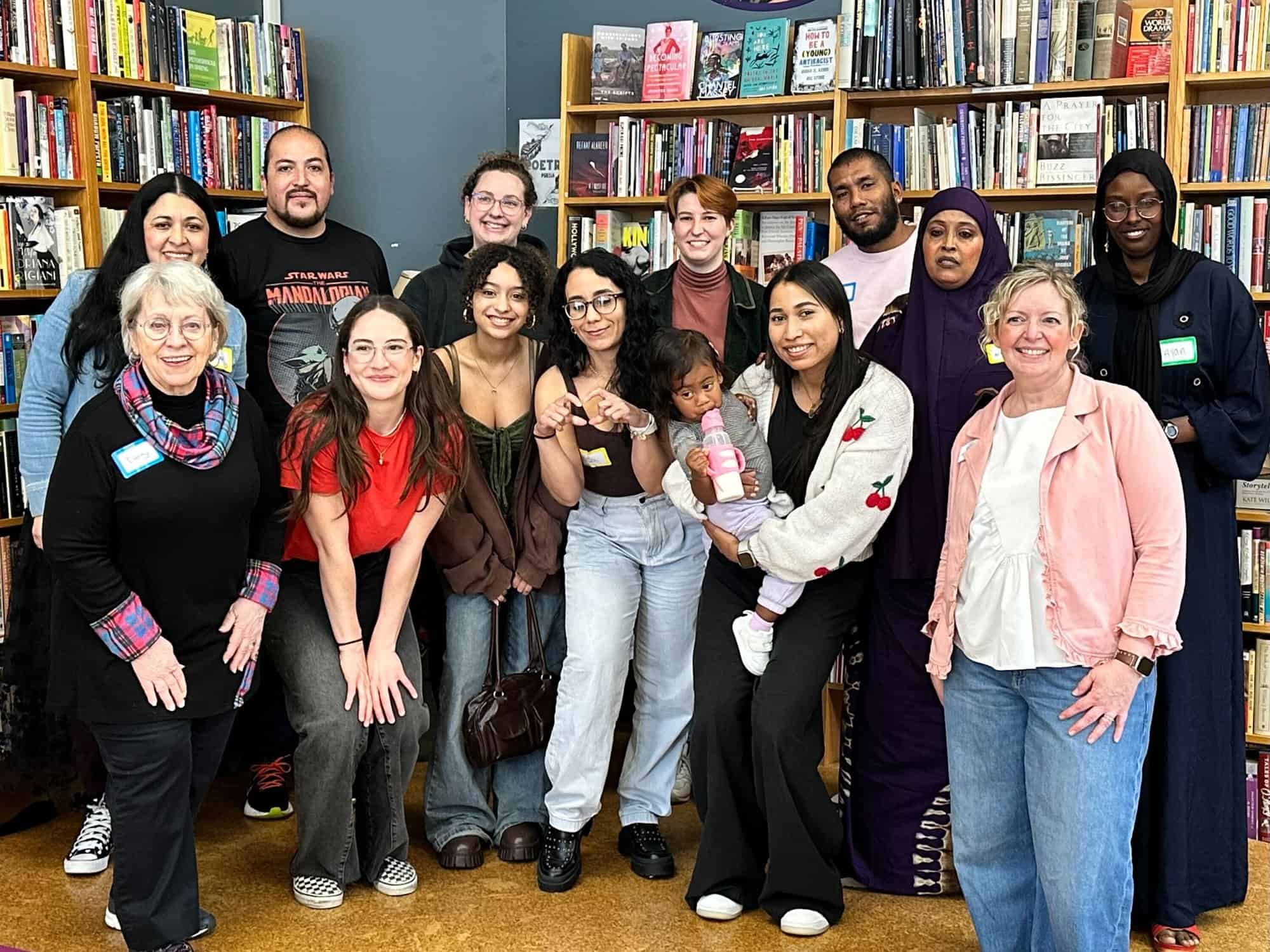 A group of Indy Reads volunteers and staff smiling together in the community bookstore